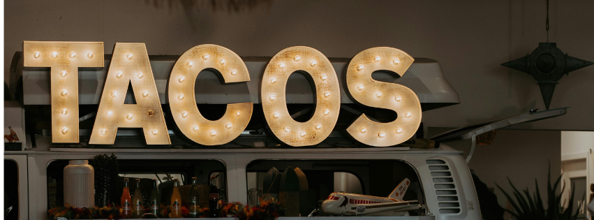 Photo of taco sign for Tacos for Tots event.