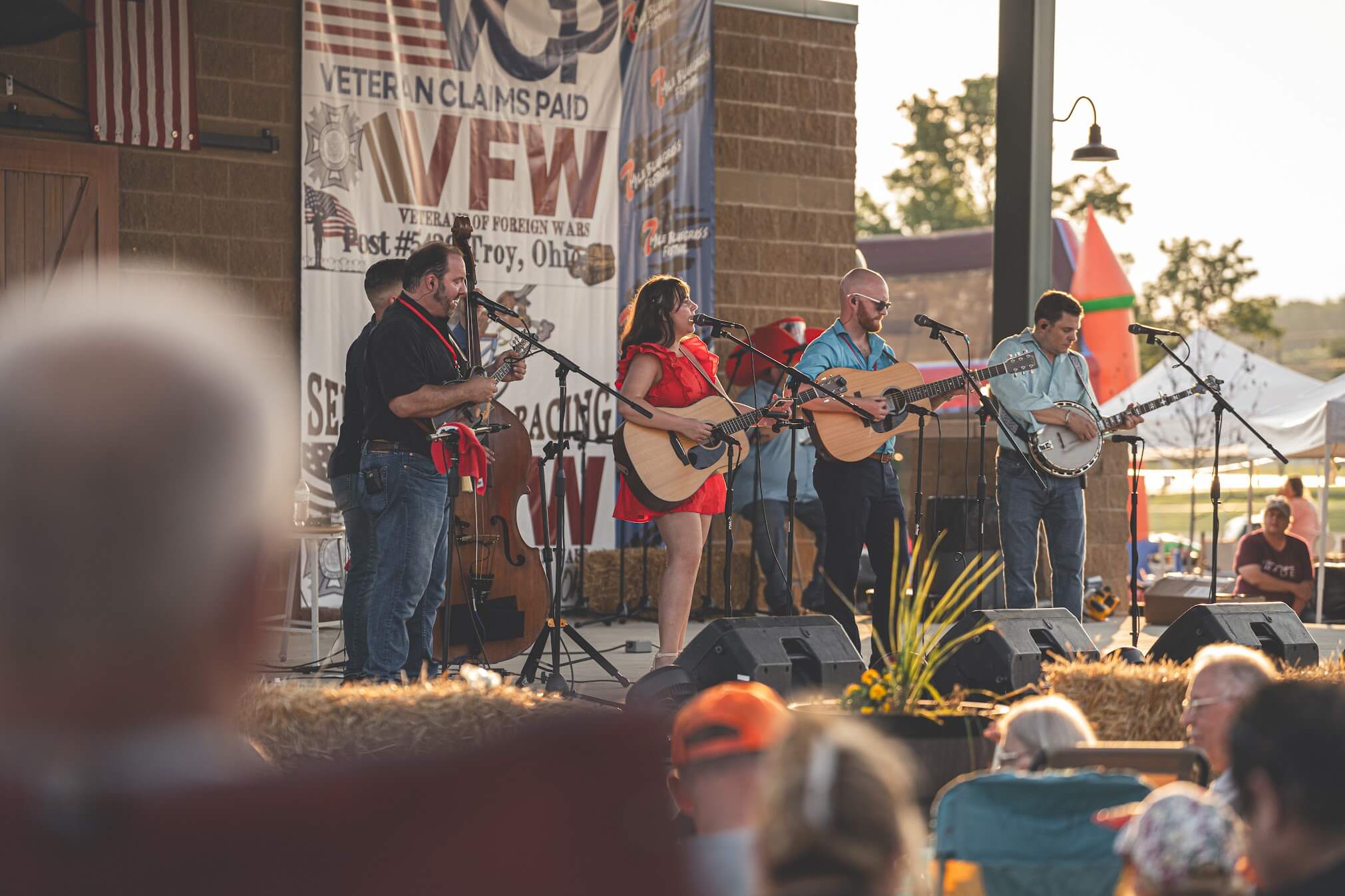 Live bluegrass band performing outdoors at the 7 Mile Bluegrass Festival in Pickaway County at golden hour